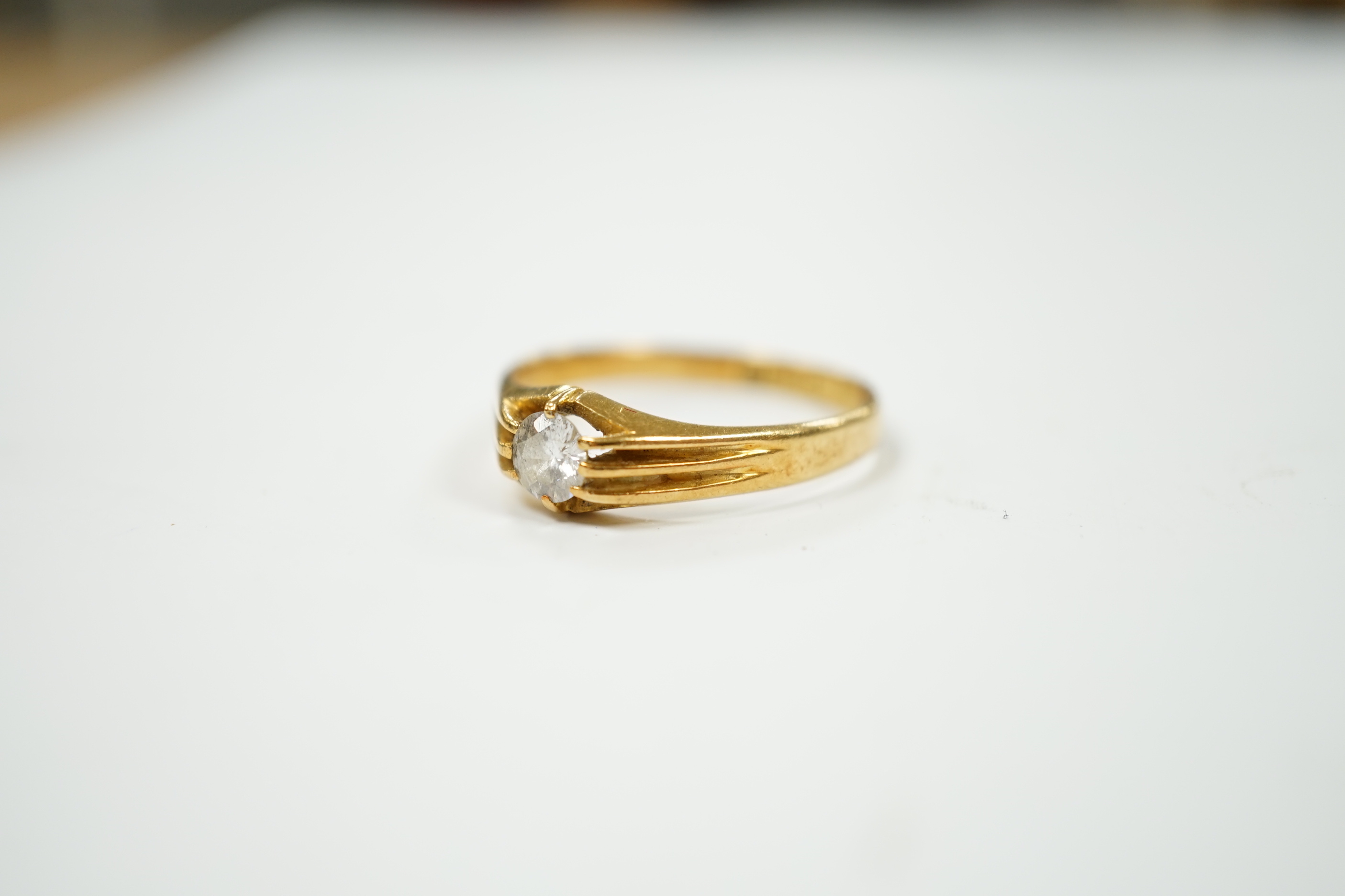A George V 18ct gold and claw set solitaire diamond ring, size U/V, gross weight 3.6 grams.